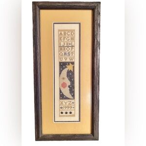 Americana/Colonial Moon, star, letters in frame.